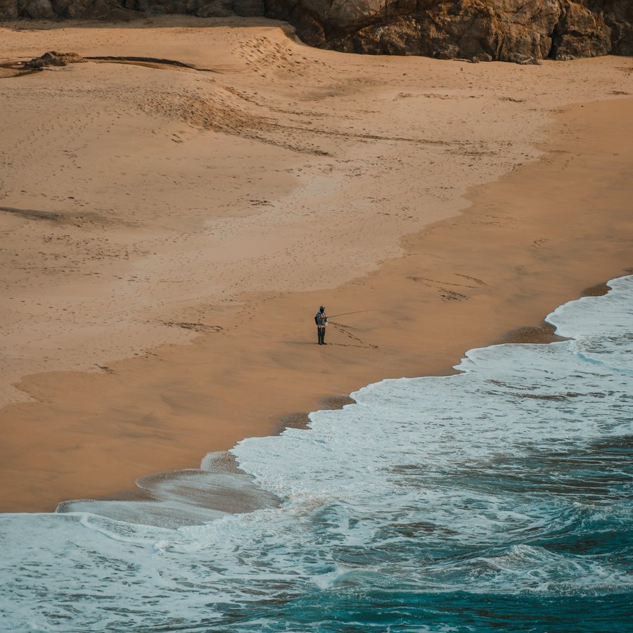 Beach scene with GlassMeter's LiDAR rangefinder reading the distance to a fisherman