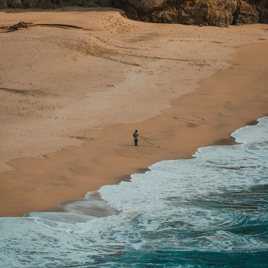 Beach scene with GlassMeter's LiDAR rangefinder reading the distance to a fisherman
